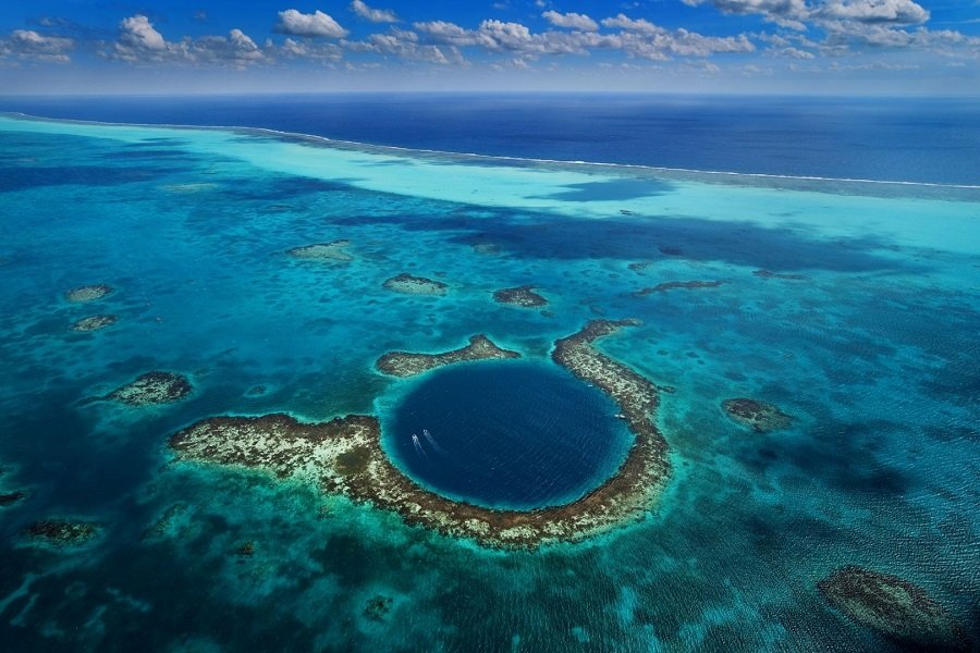 Blue holes in the sea are usually darker in color than their surroundings.