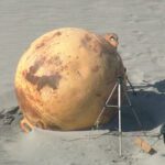 The mysterious sphere on a beach