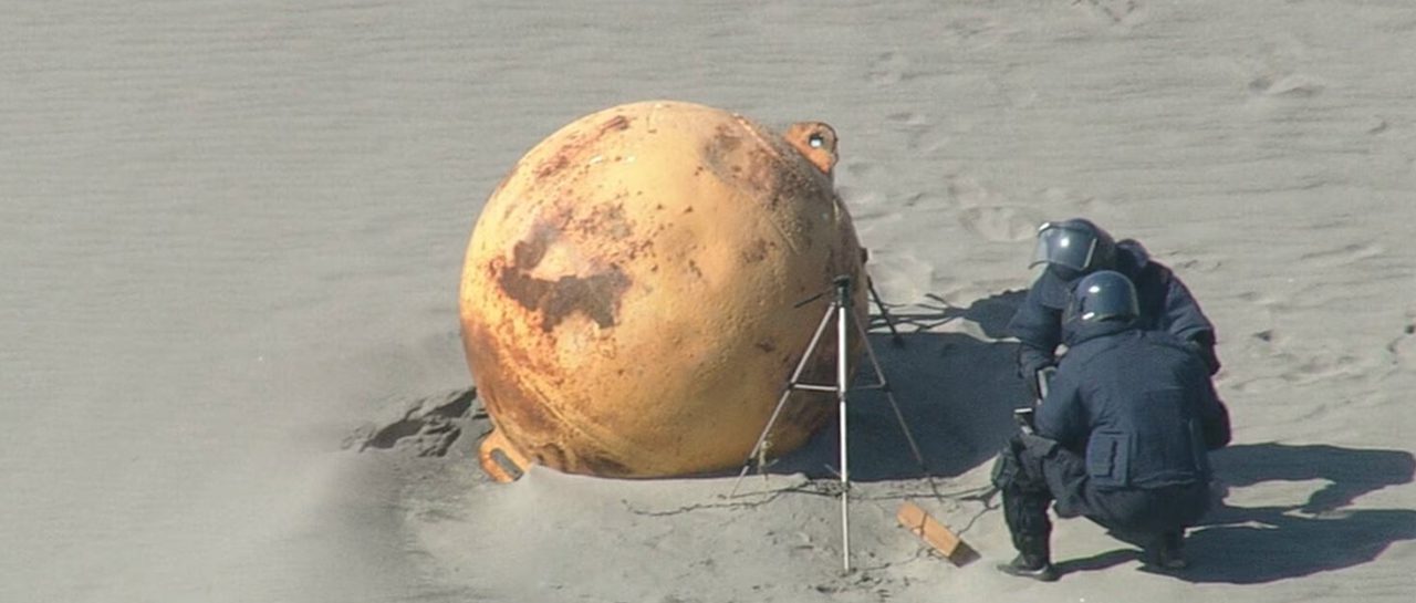 Mysterious sphere on a beach intrigues the Japanese.